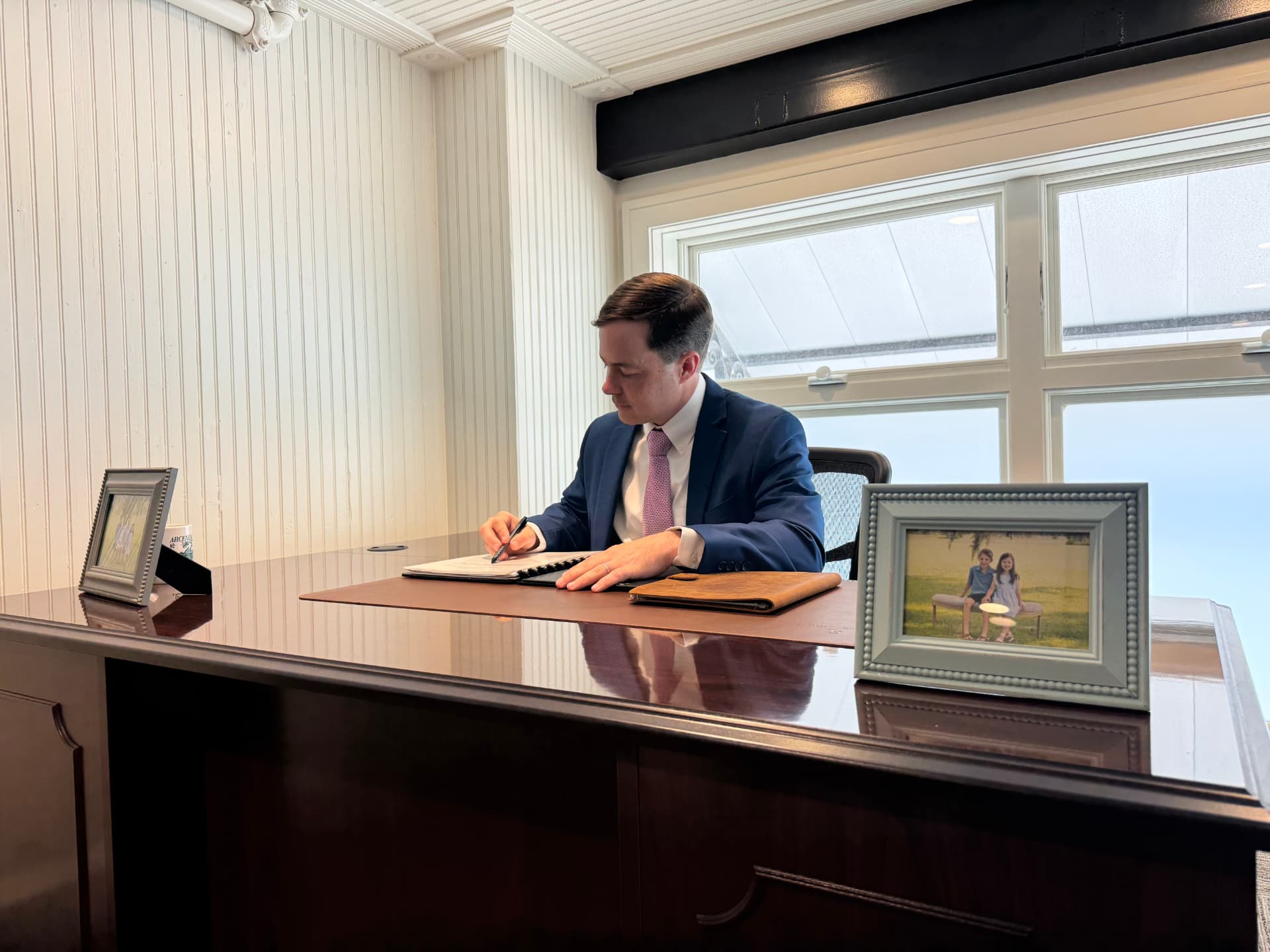 Paul Arceneaux reviewing notes at his desk in the Thibodaux law office